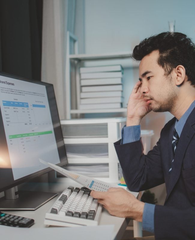 Asian male businessman working in the room. Startup company employees are working in the office at night, overtime, busy work, hard work. Overtime concept.
